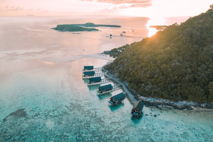 aerial_east_overwater_suites_at_sunset_with_elang_and_lidi_background