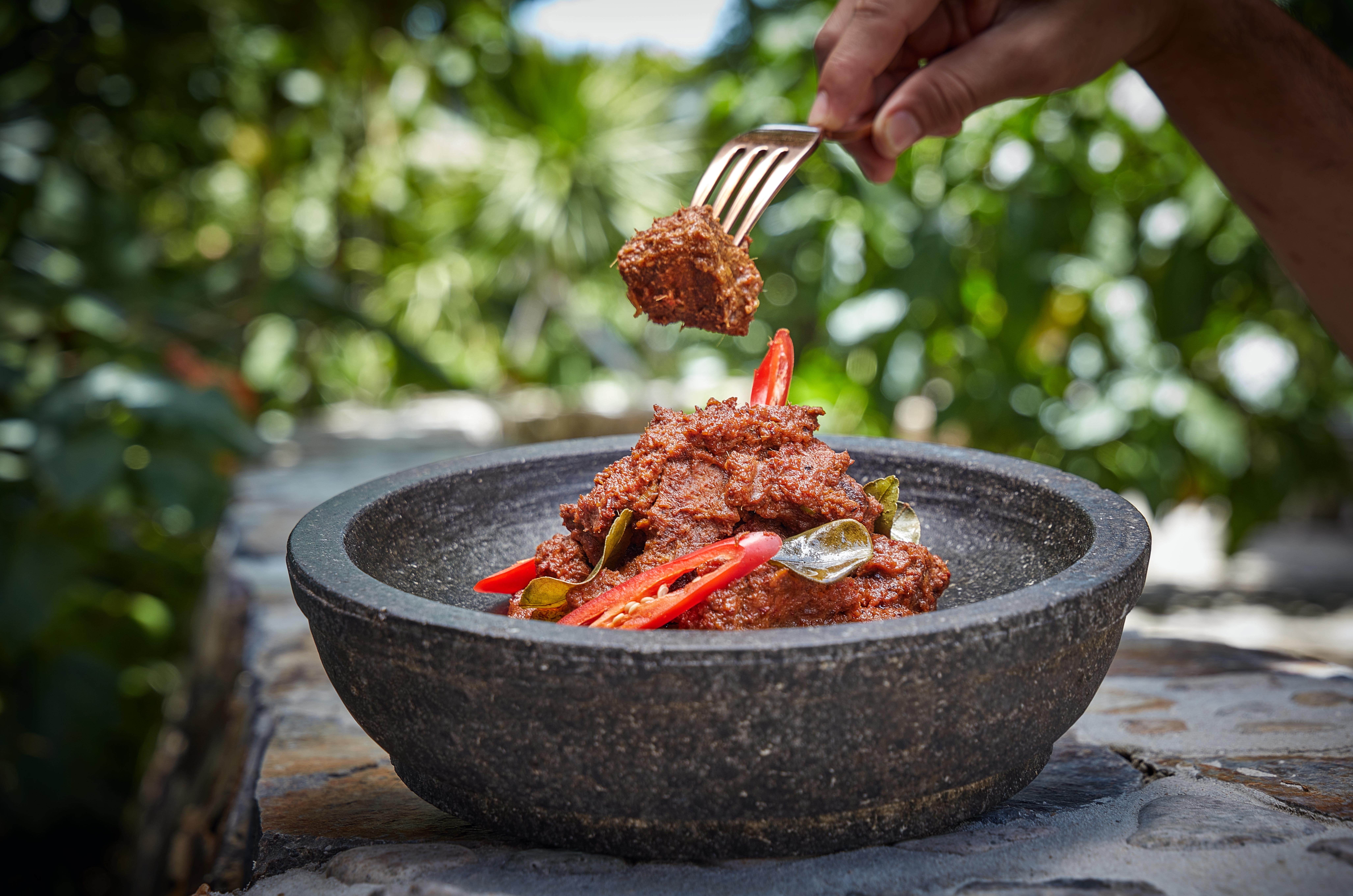 beef_rendang_in_stone_dish_fork_treetops