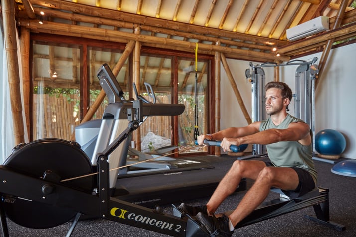 fitness_man_using_rowing_machine_at_aura_gym