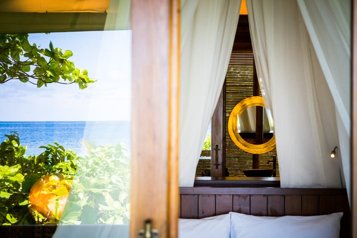 mirrors reflecting natural light in the bathroom and bedroom