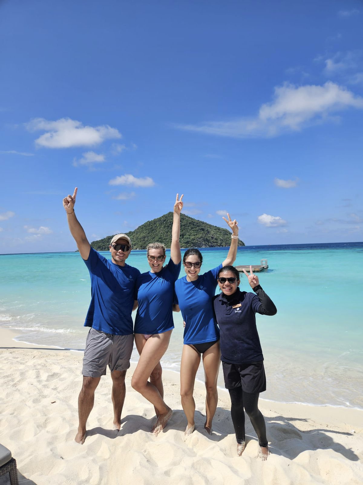 group-of-four-happy-peopleon-beach-wearing-wild-swim-tshirt