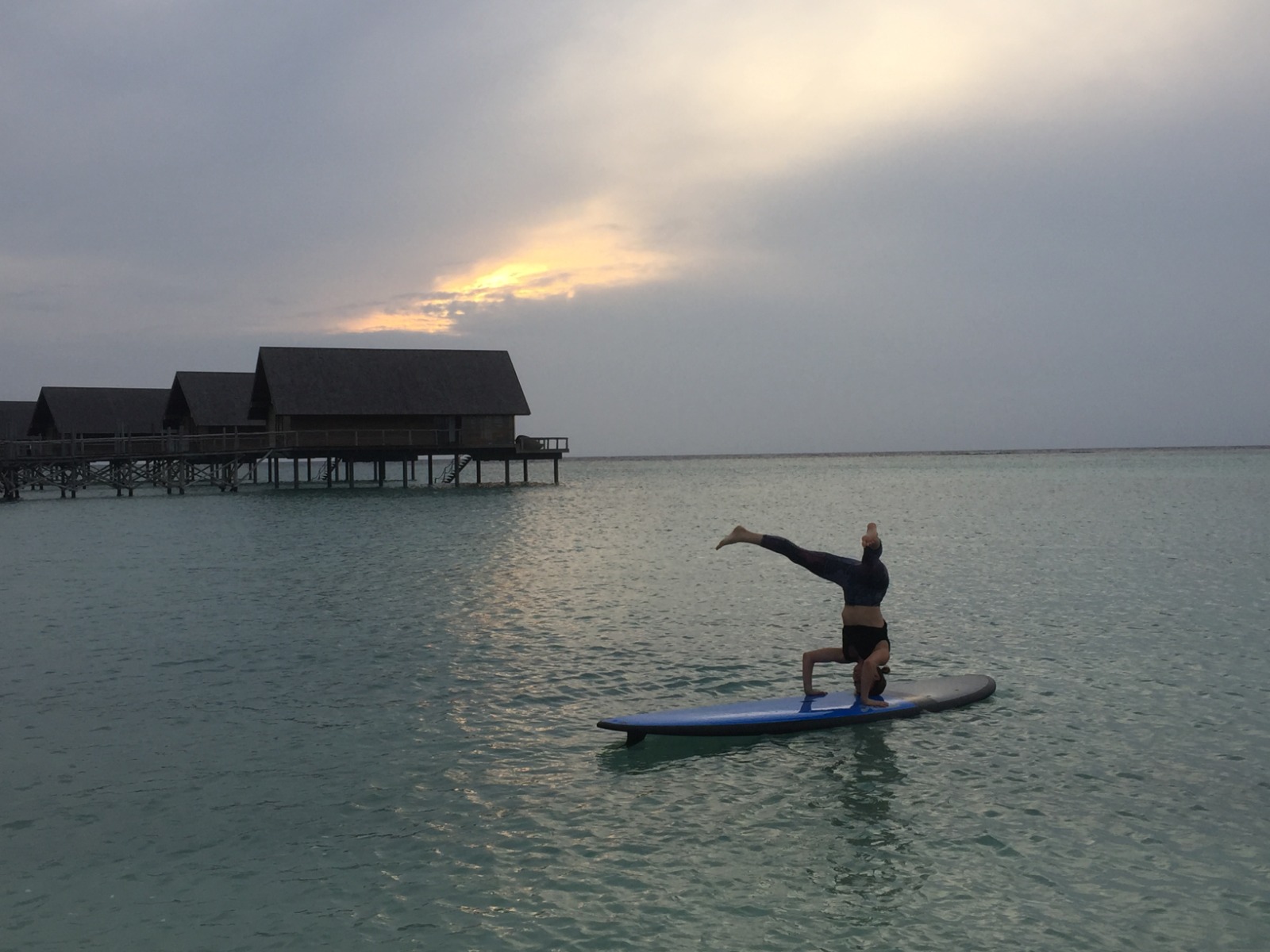 yoga and pilates floating on a paddleboard at sea