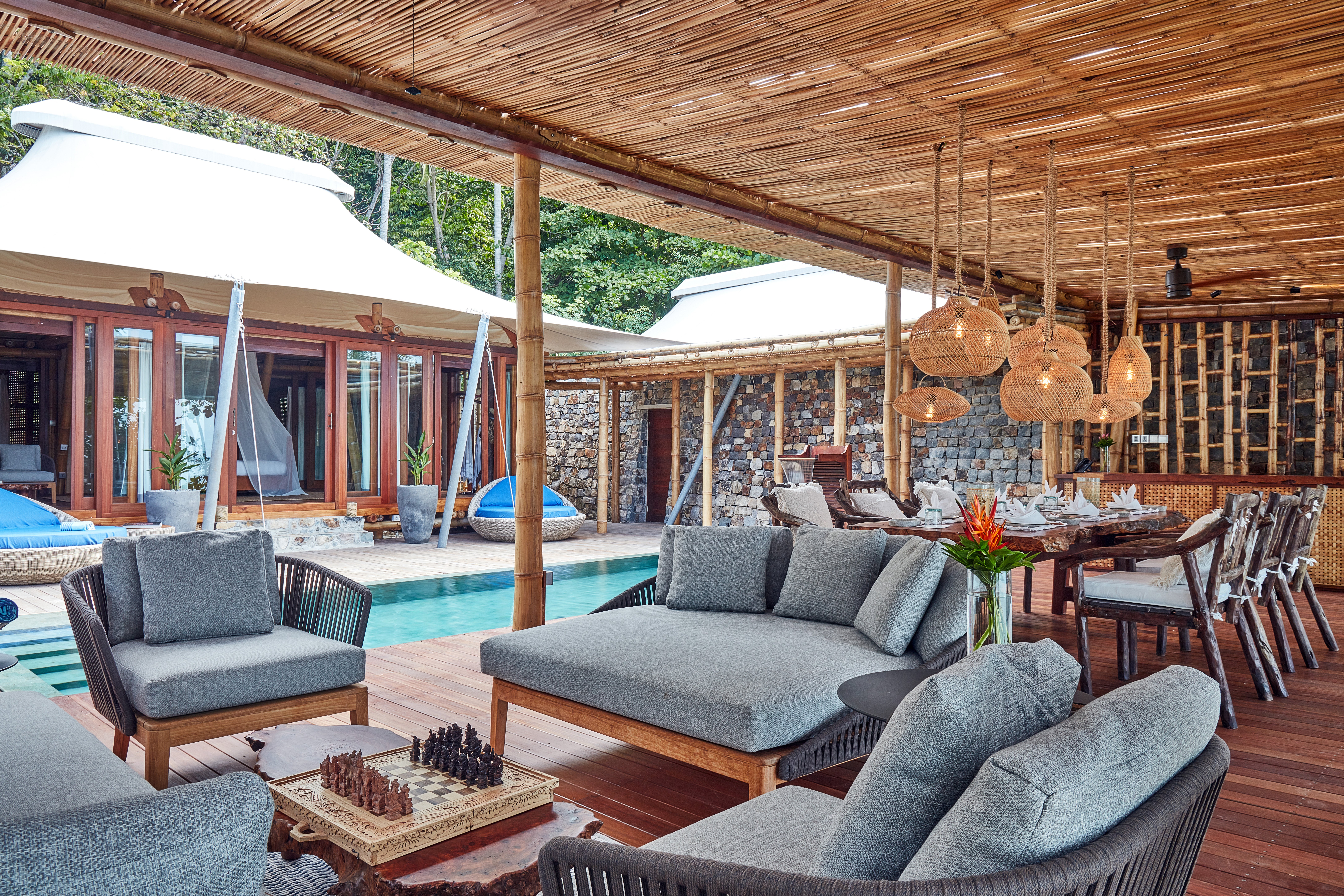 unedited_wooden_chess_in_living_lounge_sofa_dining_pavilion_plunge_pool_background_two_bed_villa