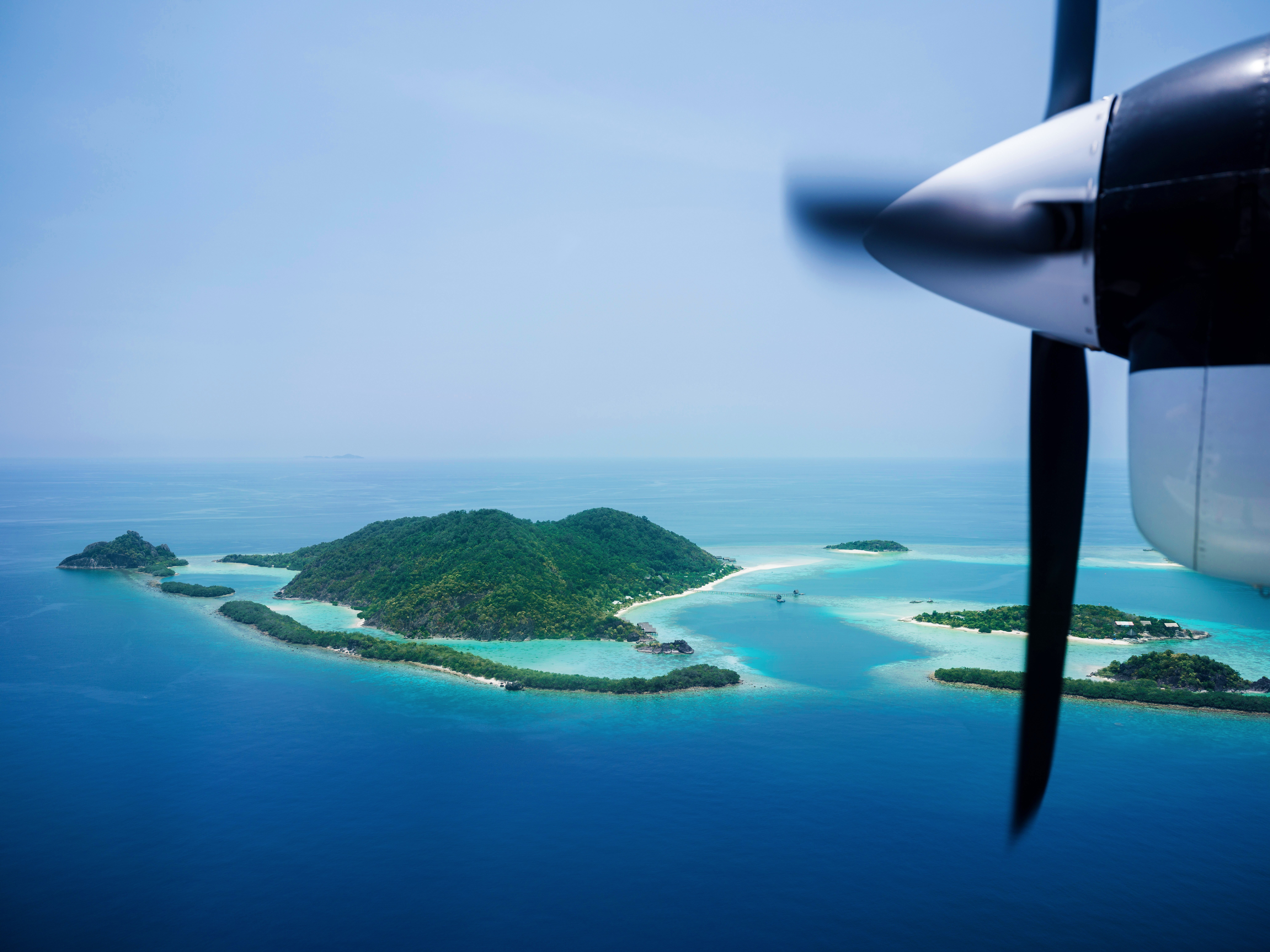 Seaplane over tropical islands, How to get to Bawah Reserve Indonesia