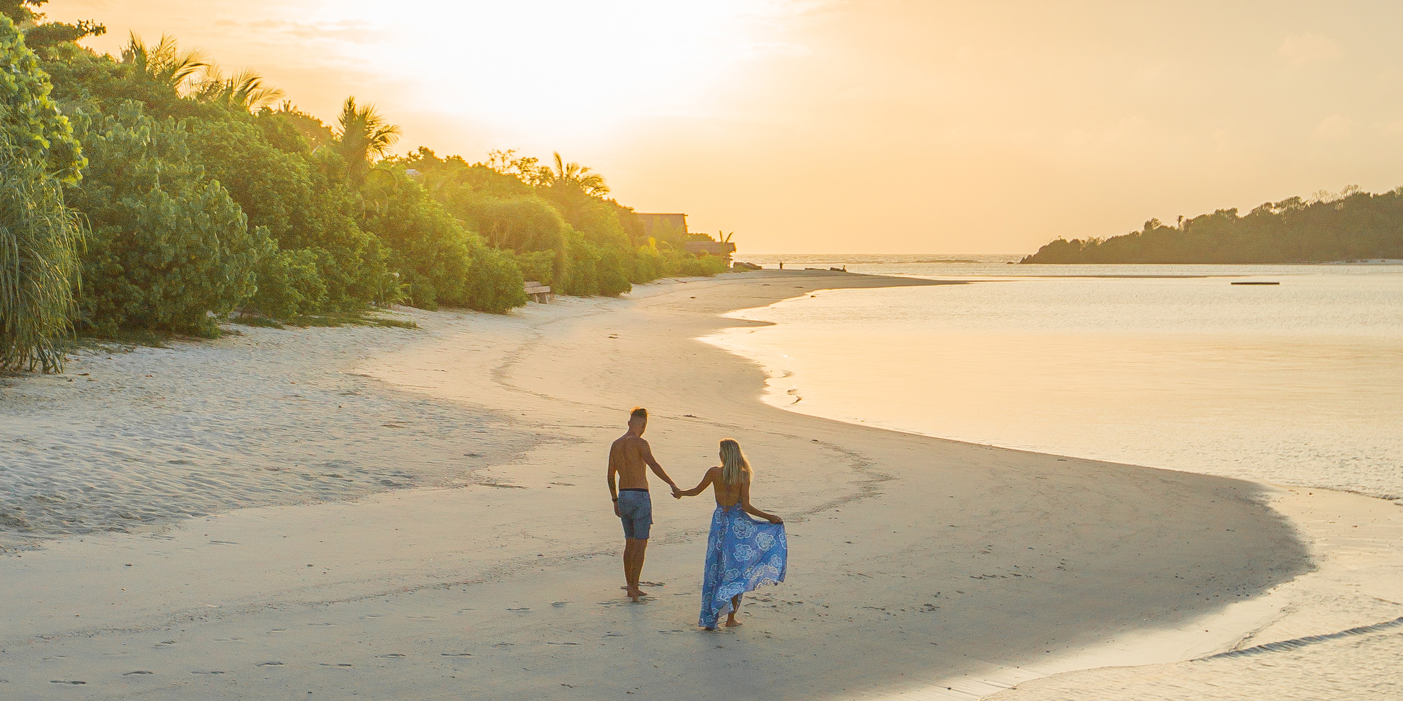 Bawah Reserve honeymoon destination, honeymooners on the beach at Sunset