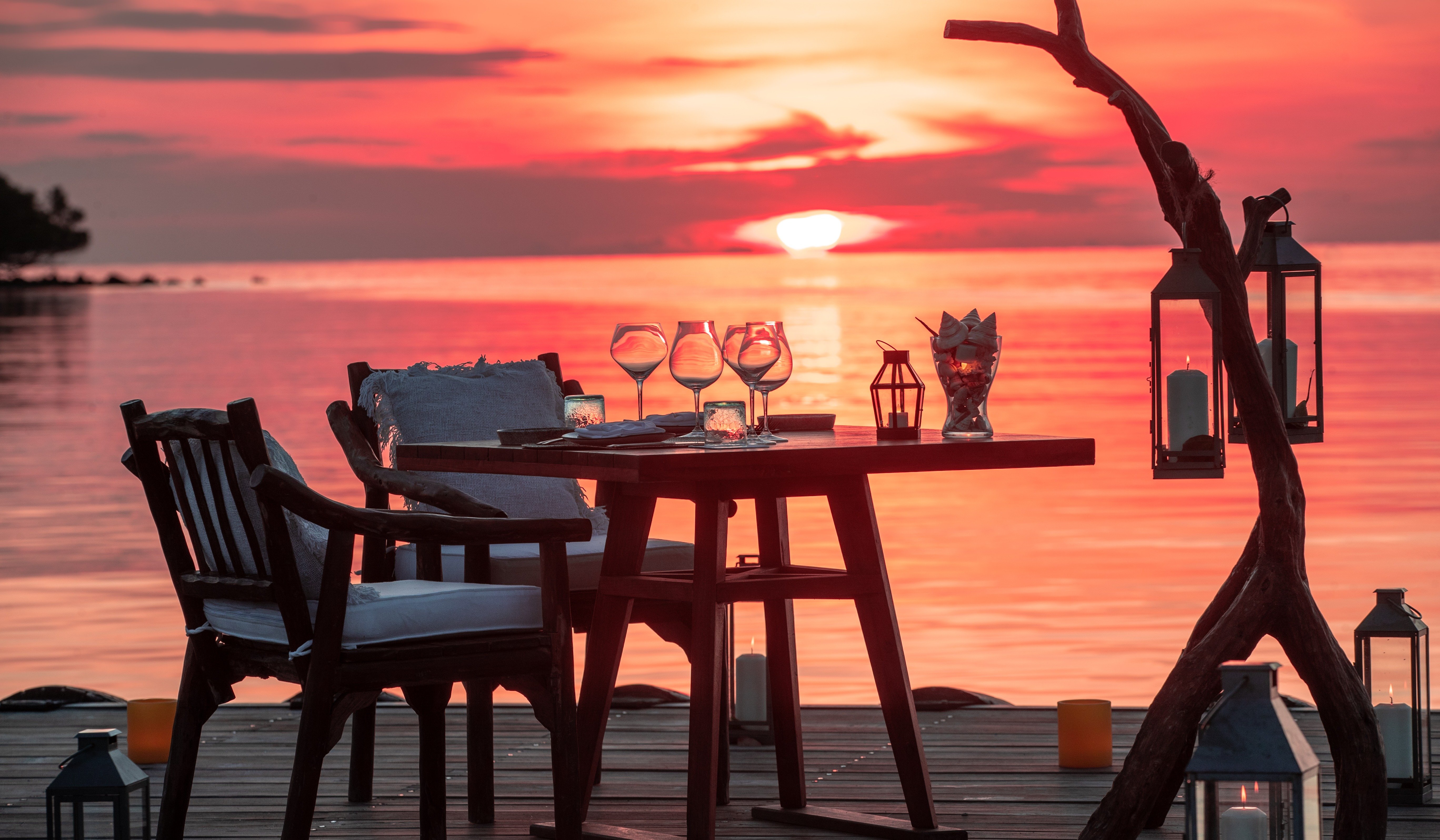 Al fresco dining jetty sunset and red skies at Bawah Reserve Indonesia