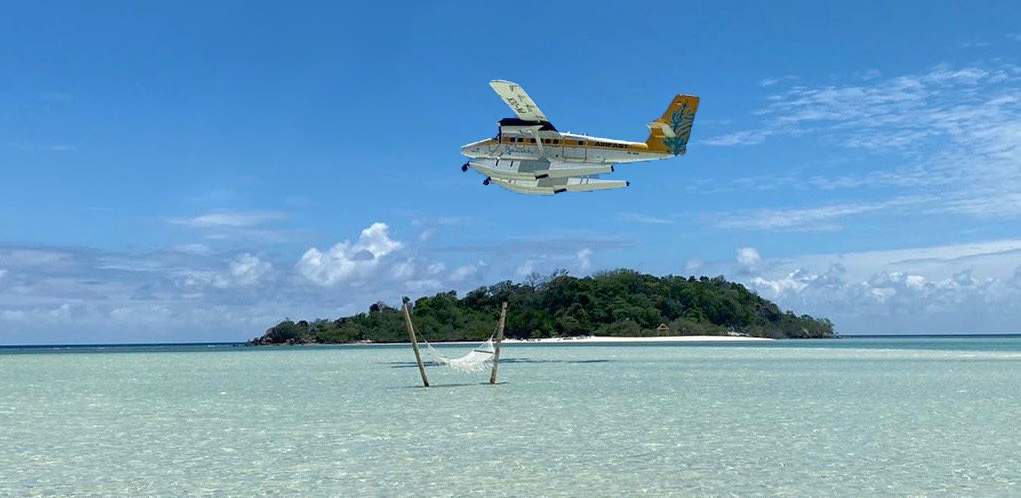 Seaplane and hammock in the sea, private island, Bawah Reserve, Indonesia